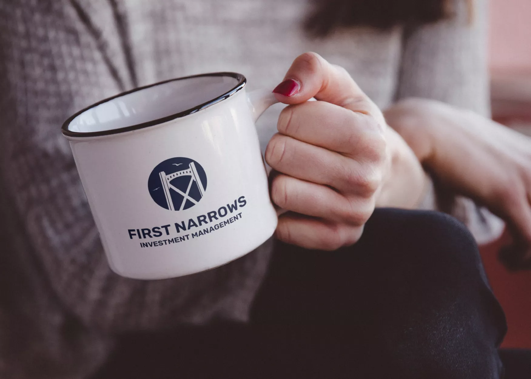 a woman holding a white cup